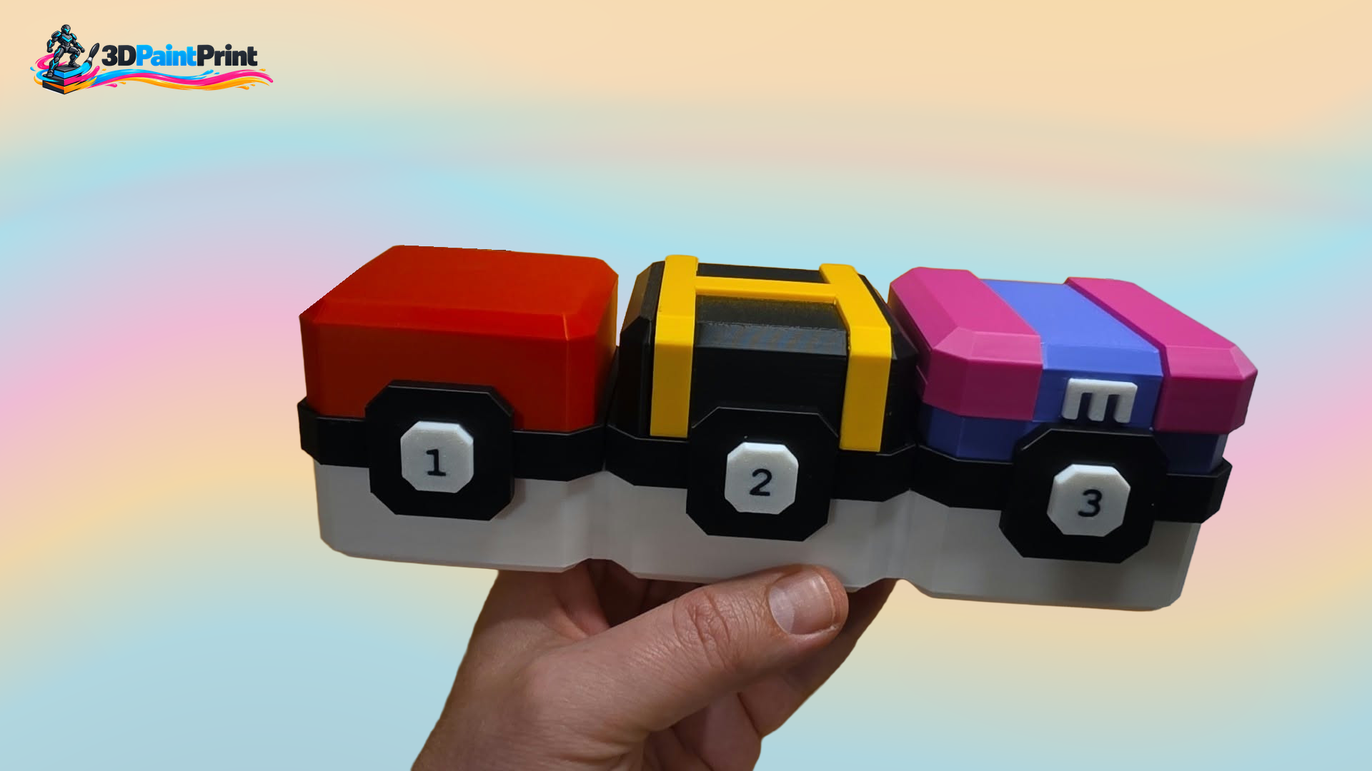 Three-compartment Beyblade storage box with closed coloured lids and numbered front closures, held in the original supporting hand.