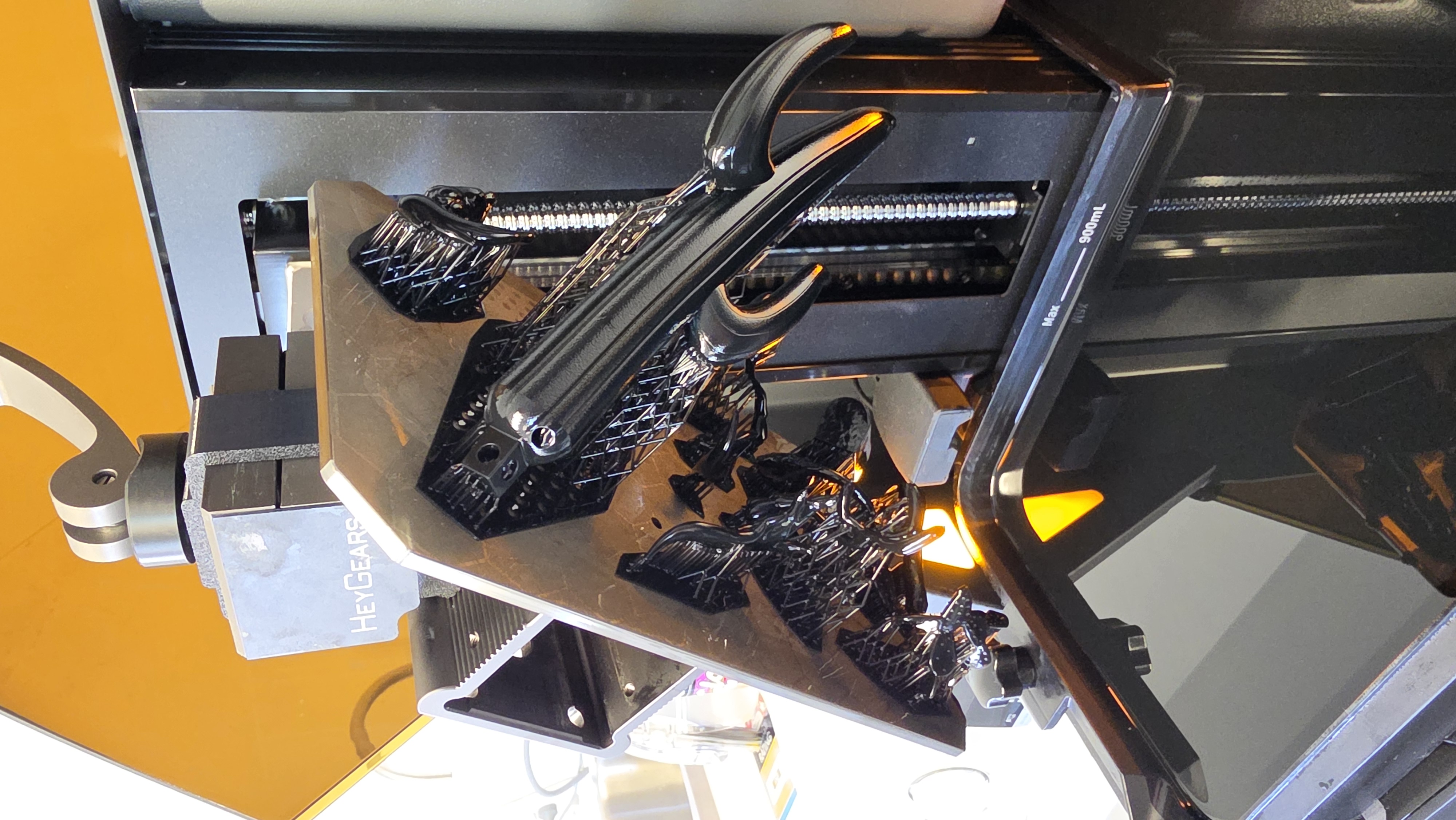 Resin components with print supports on the build platform before finishing